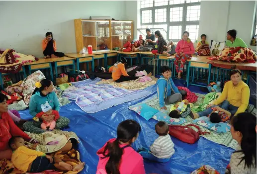  ?? (VNA/Manh Linh via Reuters) ?? VIETNAMESE RESIDENTS take shelter in an evacuation center before Tembin hits land in Ho Chi Minh City yesterday.