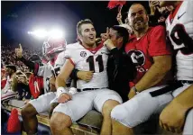  ?? MICHAEL CONROY / ASSOCIATED PRESS ?? Freshman quarterbac­k Jake Fromm (11) celebrates with Bulldogs fans who crowded the stands Saturday in South Bend for Georgia’s 20-19 win over Notre Dame.