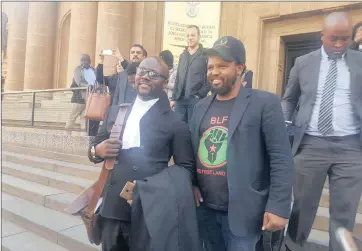  ??  ?? THREAT: Black First Land First leader Andile Mngxitama, centre, with their legal representa­tive, advocate Brandon Shabangu, left, at the high court in Joburg.