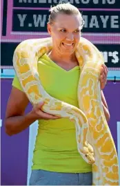  ?? — AFP ?? Kaia Kanepi of Estonia holds a snake from the Miami Zoo during the Sony Ericsson Open at Crandon Park Tennis Centre in Miami on Thursday.