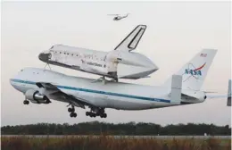  ?? (Reuters) ?? THE SPACE SHUTTLE Discovery, attached to a modified NASA 747 aircraft, takes off in Cape Canaveral yesterday.