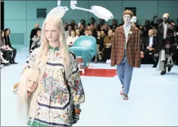  ?? PICTURE: AP/AFRICAN NEWS AGENCY (ANA) ?? A model carries a fake head as she wears a creation as part of the Gucci women’s Autumn/ Winter 2018-19 collection, presented during the Milan Fashion Week, in Milan, Italy.