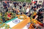  ?? — AP ?? BSF officials pay tribute to constable Brijendra Bahadur, who was killed in firing from the Pakistan side, during a ceremony in Jammu on Friday.