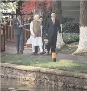  ??  ?? Prime Minister Narendra Modi with Chinese President Xi Jinping take a walk along the East Lake in Wuhan, China, on Saturday.