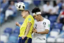  ?? THE ASSOCIATED PRESS ?? Sweden’s Viktor Claesson heads the ball past South Korea’s Lee Yong during a Group F match between Sweden and South Korea at World Cup.