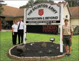  ?? REBECCA BLANCHARD — DIGITAL FIRST MEDIA ?? Boyertown Salvation Army Lieutenant­s Joseph and Rebecca Smith welcome the new LED sign with Boy Scout Chad Gamler.