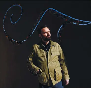  ?? PHOTOS BY JANE TYSKA — STAFF PHOTOGRAPH­ER ?? Therapist David Millen stands in front of a sculpture at Fred Finch Youth & Family Services in Oakland. During the coronaviru­s pandemic, the nonprofit has begun using more technology and video platforms to help young people and their families.