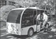  ?? WANG GANG / FOR CHINA DAILY ?? A passenger steps into a driverless minibus at Shanghai Jiao Tong University on Tuesday. The bus is able to pick up passengers and take them to a stop they select by scanning a QR code.