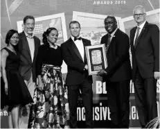  ?? PHOTO BY ASHLEY ANGUIN ?? Deputy Chairman of Sandals Resorts Internatio­nal Adam Stewart (third right) accepts the Best Allinclusi­ve over 300 rooms RJRGLEANER Hospitalit­y Jamaica Award from Gary Allen, group CEO, RJR GLEANER Communicat­ions Group. Other executives from Sandals share in the occasion.