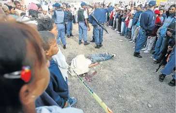  ??  ?? GRIM END: A youngster gunned down in a gang fight. This is a common occurrence in Hanover Park, and although the community usually knows who the perpetrato­rs are within a few hours of the murder, no one is willing to testify