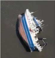  ?? MICHAEL SNYDER — THE ASSOCIATED PRESS ?? A large ship lists on its side in the St. Andrew Bay, at Panama City, Fla., Thursday, Oct. 11, 2018. The devastatio­n inflicted by Hurricane Michael came into focus Thursday with rows upon rows of homes found smashed to pieces, and rescue crews began making their way into the stricken areas in hopes of accounting for hundreds of people who may have stayed behind.