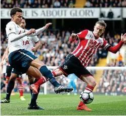  ?? REUTERS/PA ?? Spot of bother: Dele Alli (left) beats Steven Davis to the ball, goes to ground (centre) and successful­ly appeals for a penalty