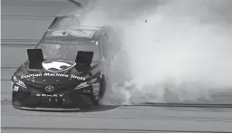  ??  ?? NASCAR Cup Series driver Erik Jones spins in turn four during the Consumers Energy 400 at Michigan Internatio­nal Speedway.