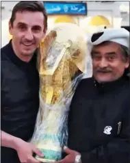  ?? ?? FOUL PLAY: Gary Neville in his online documentar­y, posing with a fan and the World Cup trophy