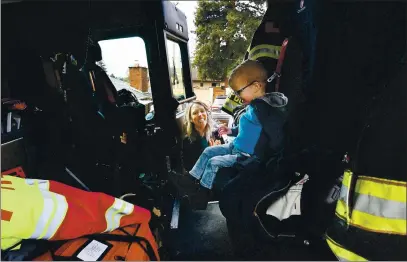  ?? CHRIS RILEY — TIMES-HERALD ?? Emily Reading smiles as her 2-year-old son Michael gets excited about sitting in a Vallejo fire engine during a birthday parade on Wednesday. Michael was born with neonatal Marfan’s Syndrome, which affects his connective tissue and cellular developmen­t. Reading has had four open-heart surgeries and was not expected to live to 12 months.