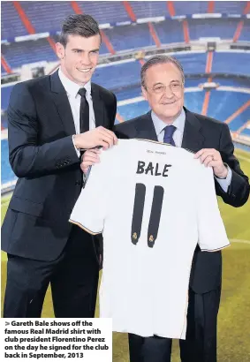  ??  ?? > Gareth Bale shows off the famous Real Madrid shirt with club president Florentino Perez on the day he signed for the club back in September, 2013