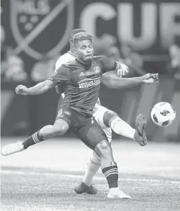  ?? MARK J. REBILAS/USA TODAY SPORTS ?? Atlanta United forward Josef Martinez (7) battles Portland Timbers defender Larrys Mabiala (33) for the ball during the MLS Cup on Saturday at Mercedes-Benz Stadium.