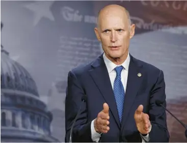  ?? ANNA MONEYMAKER/GETTY ?? Sen. Rick Scott, R-Fla., talks to reporters last month about negotiatio­ns on the debt limit.