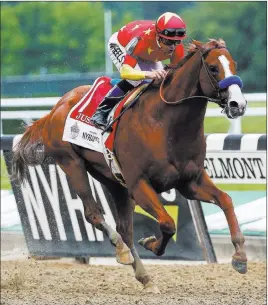  ?? Peter Morgan ?? The Associated Press Justify, with jockey Mike Smith up, crosses the finish line to win the Belmont Stakes on Saturday in Elmont, N.Y., and secure the Triple Crown.