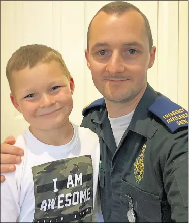  ?? Picture: London Ambulance Service NHS Trust ?? Emergency ambulance crew member Thomas Denning, from Tonbridge, with his son George