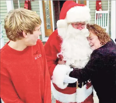  ?? Hearst Connecticu­t Media file photo ?? Geraldine DeJulila hugs her father, Jerry DeJulia, playing Santa, as his grandson, Eric Forsbert, then-13, looks on during Jerry's 2011 surprise visit. Jerry normally spends the winter in Florid,a but he wanted to surprise his family that year.