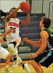  ?? BARRY TAGLIEBER - FOR DIGITAL FIRST MEDIA ?? Perk Valley’s Kevin Bernabe goes to the hoop as Daniel Boone’s Dylan Walker defends.