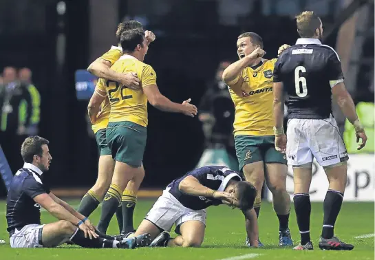  ??  ?? Australia are elated and Scotland disconsola­te after the Aussies’ narrow victory at Murrayfiel­d on Saturday.