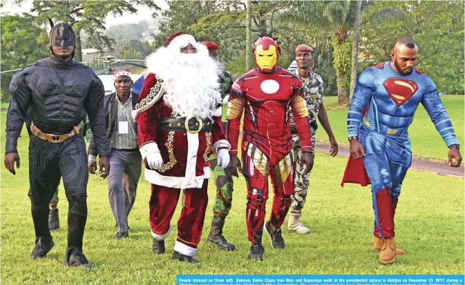  ??  ?? People dressed as (from left) Batman, Santa Claus, Iron Man and Superman walk at the presidenti­al palace in Abidjan on December 23, 2017, during a Christmas event organized by the Children of Africa Foundation. The event, organized by Ivory Coast’s...