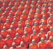  ?? AP ?? Troops wearing gas masks and bright orange suits parade during North Korea’s 73rd anniversar­y in Pyongyang.