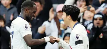  ?? REUTERS ?? SON HEUNG-MIN celebrates scoring Tottenham’s third goal against Leicester with Moussa Sissoko at Wembley yesterday. |