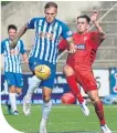  ??  ?? Killie’s Lee Erwin and Queens’ Dean Kindlan fight for the ball