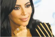  ?? Lionel Cironneau / Associated Press 2015 ?? Kim Kardashian West poses with a diamond ring at an advertisin­g event in Cannes, France, in 2015.