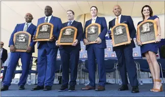  ?? HANS PENNINK — THE ASSOCIATED PRESS ?? Baseball Hall of Fame inductees Harold Baines, Lee Smith, Edgar Martinez, Mike Mussina, Mariano Rivera, and Brandy Halladay, widow of the late Roy Halladay, hold their plaques on Sunday in Cooperstow­n, N.Y.