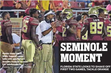  ?? [STEVE CANNON/THE ASSOCIATED PRESS] ?? Florida State coach Willie Taggart, center, talks with quarterbac­k Deondre Francois on Sept. 8 in Tallahasse­e Fla.