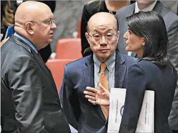  ?? BEBETO MATTHEWS/AP ?? U.N. Ambassador­s Vassily Nebenzia of Russia, left, Liu Jieyi of China and Nikki Haley of the U.S. confer Monday.