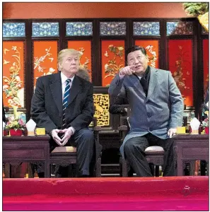  ?? The New York Times/DOUG MILLS ?? President Donald Trump and Chinese President Xi Jinping watch a performanc­e of a traditiona­l Chinese opera Wednesday in the Forbidden City in Beijing. Their wives joined them for the performanc­e.