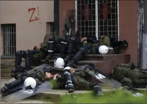  ?? (AP/Marjan Vucetic) ?? Polish soldiers, part of the peacekeepi­ng mission Tuesday in Kosovo KFOR, rest in front of a municipal building in the town of Zvecan, northern Kosovo.