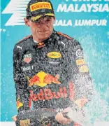  ?? Picture: GETTY IMAGES/LARS BARON ?? DOUBLE CELEBRATIO­N: Max Verstappen, of the Netherland­s, celebrates his win for team Red Bull in Malaysia