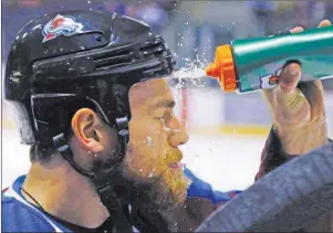  ?? AP PHOTO ?? Colorado Avalanche centre Ryan O'Reilly cools off with a splash of water to the face before the start of a preseason NHL game against the Los Angeles Kings in Colorado Springs, Colo., on Oct. 2, 2014. The Buffalo Sabres have made newly acquired forward...