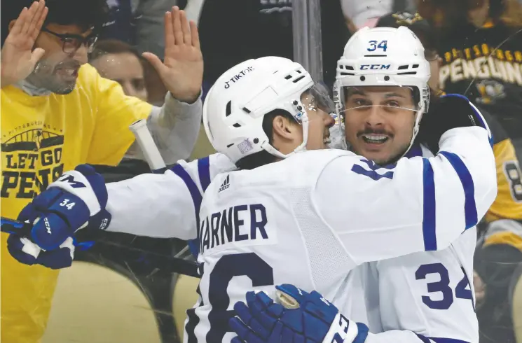  ?? CHARLES LECLAIRE/USA TODAY SPORTS ?? Toronto Maple Leafs right wing Mitchell Marner celebrates his goal with centre Auston Matthews during the first period of their game against the Penguins on Saturday night at
PPG Paints Arena in Pittsburgh. The Leafs made it nine wins in 13 games by dumping the Pens 4-1, with Marner extending his point streak to 16 games.