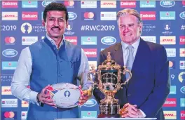  ??  ?? Indian Sports Minister Rajyavardh­an Singh Rathore (L) and Chief Executive Officer (CEO) of World Rugby Brett Gosper pose with the Webb Ellis cup during a Rugby World Cup 2019 Trophy tour event in New Delhi on Monday. The Rugby World Cup Trophy Tour...