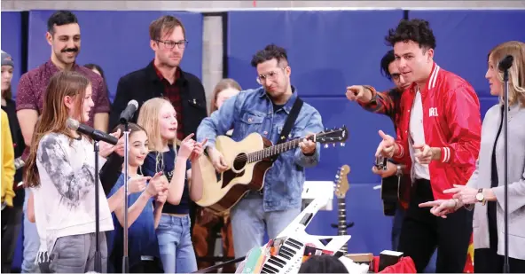  ?? DARREN MAKOWICHUK ?? Juno-award winners the Arkells perform with Calgary Arts Academy students, who in 2018 won the MusiCounts Passion Prize by performing one of the band’s songs.