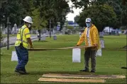  ?? NICK OXFORD / FOR THE WASHINGTON POST ?? Workers prepare the test excavation site at Oaklawn Cemetery in Tulsa, Okla., where the city plans to dig for suspected mass graves from a 1921 massacre of as many as 300 Black people.