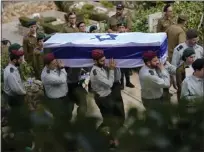  ?? ?? Israeli soldiers carry the flag-covered coffin of Maj. Tal Cohen during his funeral at the Givat Shaul cemetery in Jerusalem on Tuesday. The latest Israel-Palestinia­n war reverberat­ed around the world Tuesday, as foreign government­s tried to determine how many of their citizens were dead, missing or in need of medical help or flights home.