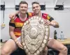  ?? PHOTO: GETTY IMAGES ?? Waikato players Jack Stratton (left) and Fletcher Smith hold the Ranfurly Shield after their side claimed it from Taranaki at Yarrow Stadium in New Plymouth on September 9.