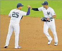  ?? N.Y. Post: Charles Wenzelberg ?? GOOD TIMES: Gleyber Torres (left) celebrates with Aaron Hicks after the Yankees’ 5-1 victory over the Red Sox in the Bombers’ homer opener.