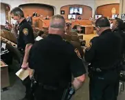  ??  ?? Police Chief William Mcmanus takes a call as he and other police officials attend the City Council meeting at the Municipal Plaza Building on Thursday.