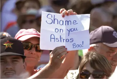  ?? John Bazemore/Associated Press ?? ■ A fan holds a sign during a spring training baseball game between the Houston Astros and the Washington Nationals on Feb. 23 in West Palm Beach, Fla. The Astros aim to move on from the sign-stealing scandal that dominated the first round of spring training before the coronaviru­s pandemic took hold.