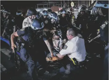  ?? AP PHOTO/JOHN MINCHILLO ?? A protester is arrested on New York’s Fifth Avenue by NYPD officers during a march in 2020, following the death of George Floyd.