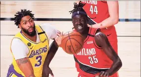  ?? Kevin C. Cox / Associated Press ?? The Lakers’ Anthony Davis, left, and the Trail Blazers’ Wenyen Gabriel fight for a loose ball during Game 2 of their first-round playoff series Thursday.